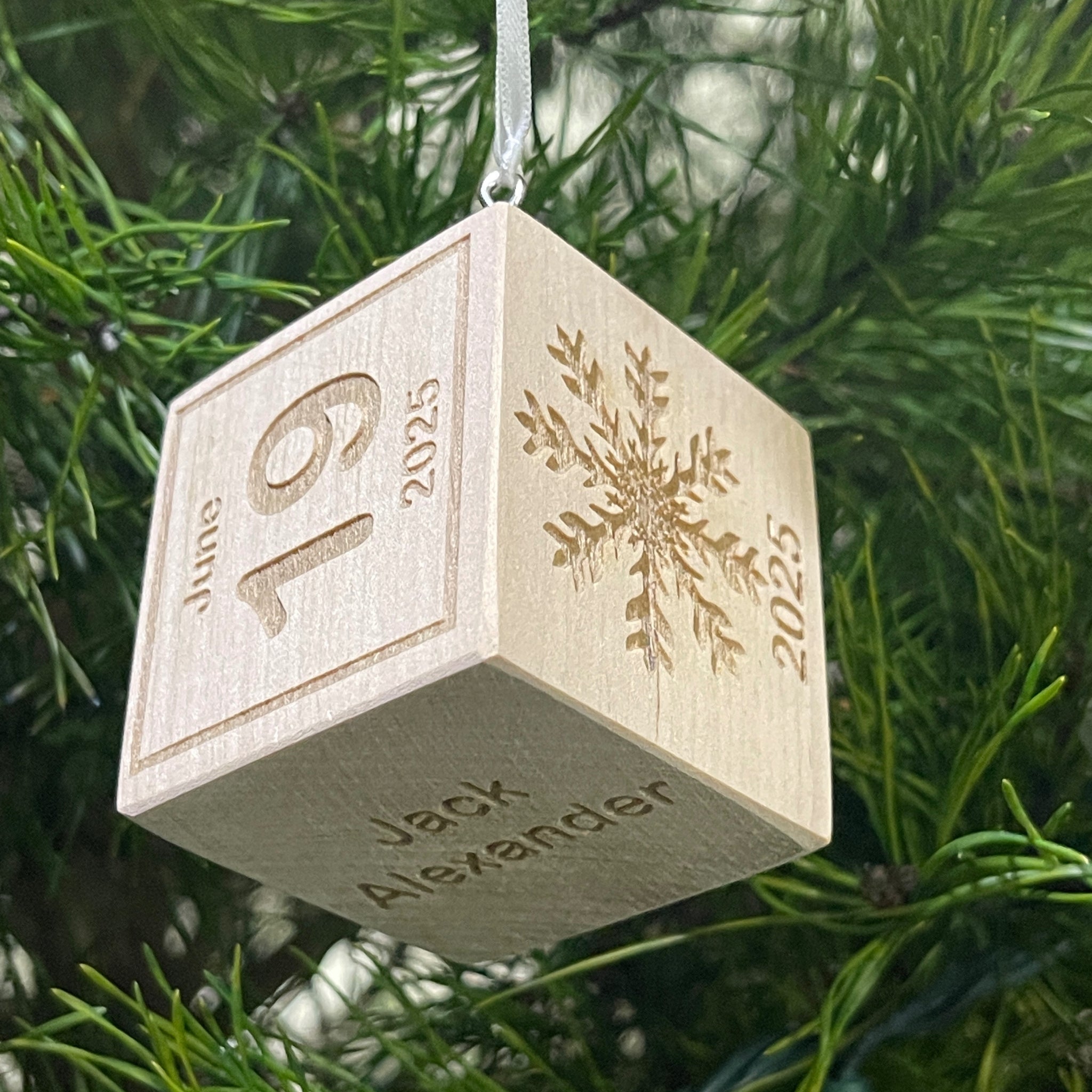 Baby holding personalized wooden baby block ornament for photoshoot