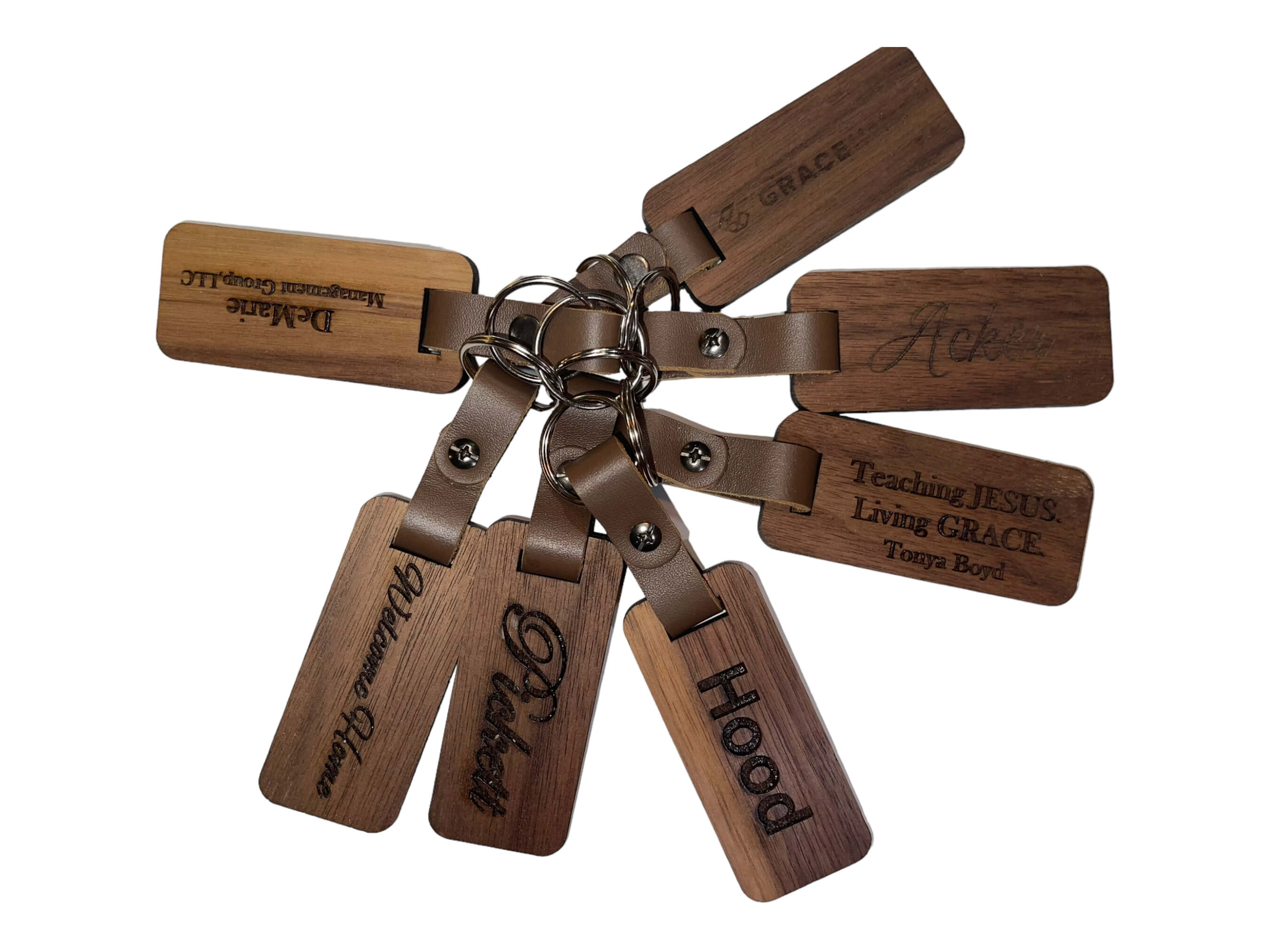 Another photo of the walnut keyrings, showing a few of the design ideas for our laser engraved walnut keyrings. See more at SawyerCustomCrafts.Com