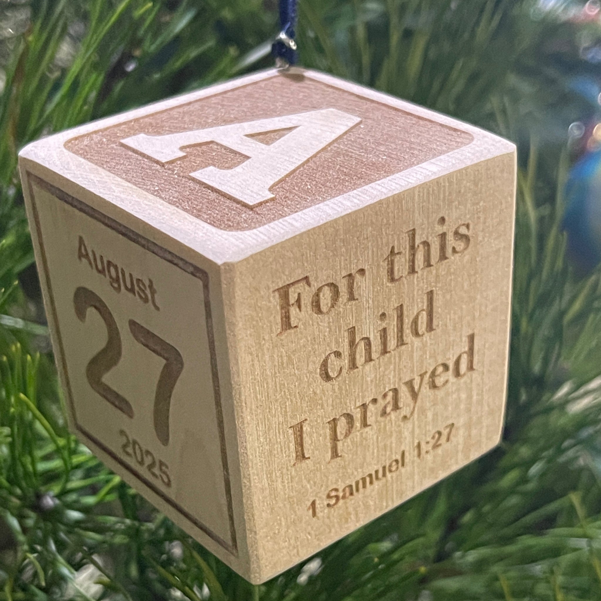 Engraved wooden baby block ornament showing custom birth stats and initial
