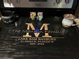 Unique kitchen accessory - stove top cover with personalized engraving and elegant black stain.