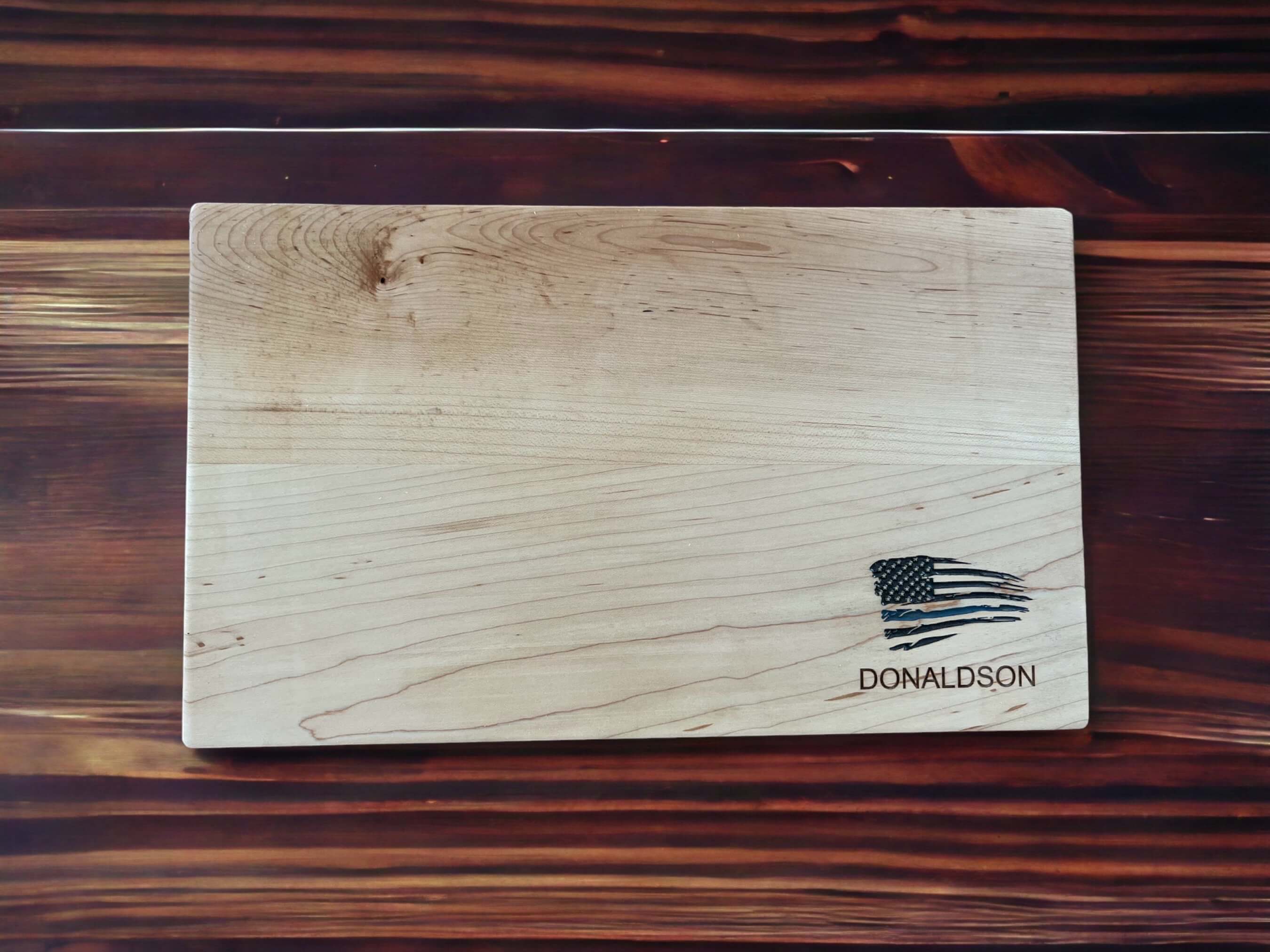 Laser-engraved thin blue line flag on hard maple cutting board