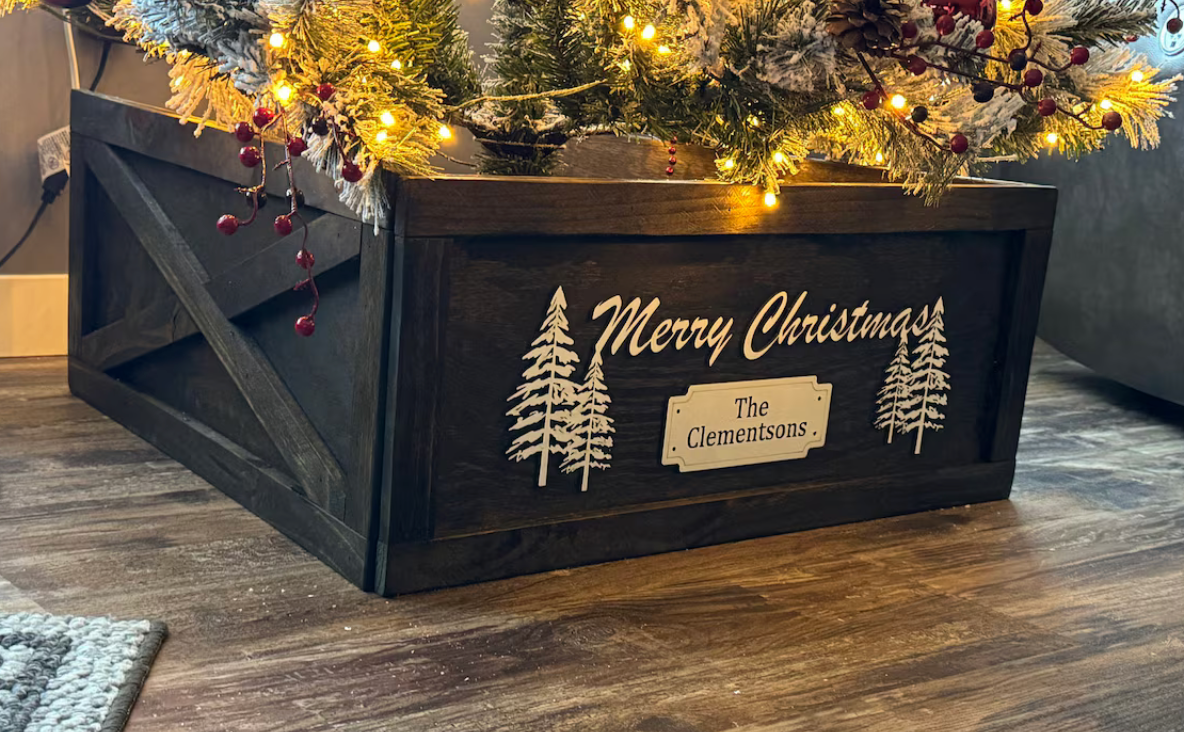 Completed wooden Christmas tree collar with X-trim, displayed under a decorated Christmas tree with warm lights