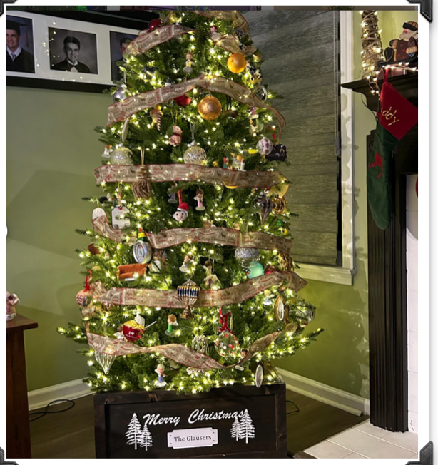 Farmhouse wooden Christmas tree collar under a decorated Christmas tree, shown beside rustic barn door Christmas décor.