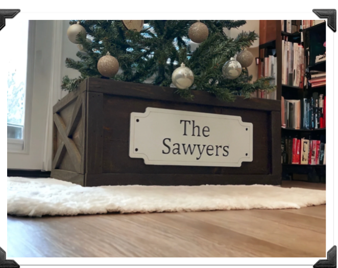 Side angle of wooden Christmas tree collar featuring personalized name sign and X-trim farmhouse style.