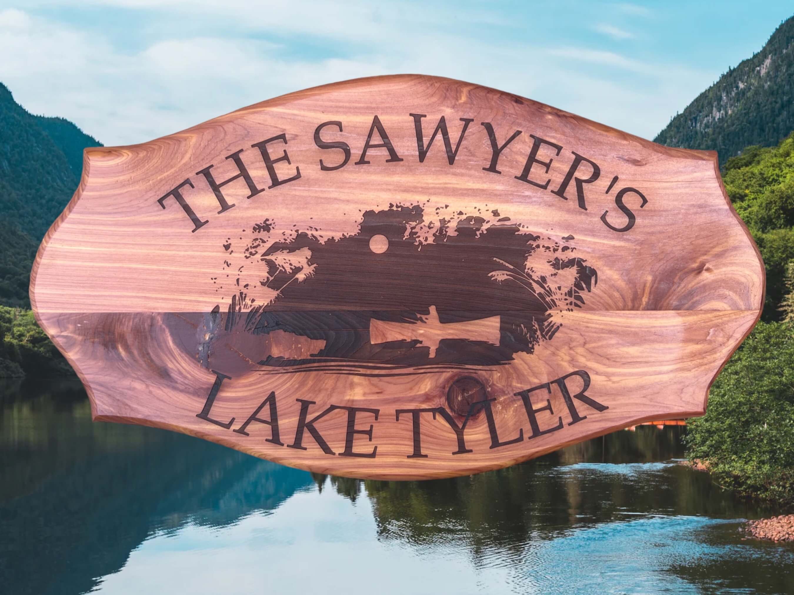 "Personalized Red Cedar Lake House Sign" Description: Close-up of a beautifully crafted red cedar lake house sign. The sign showcases laser-engraved details and is customizable with the customer's last name and lake name.