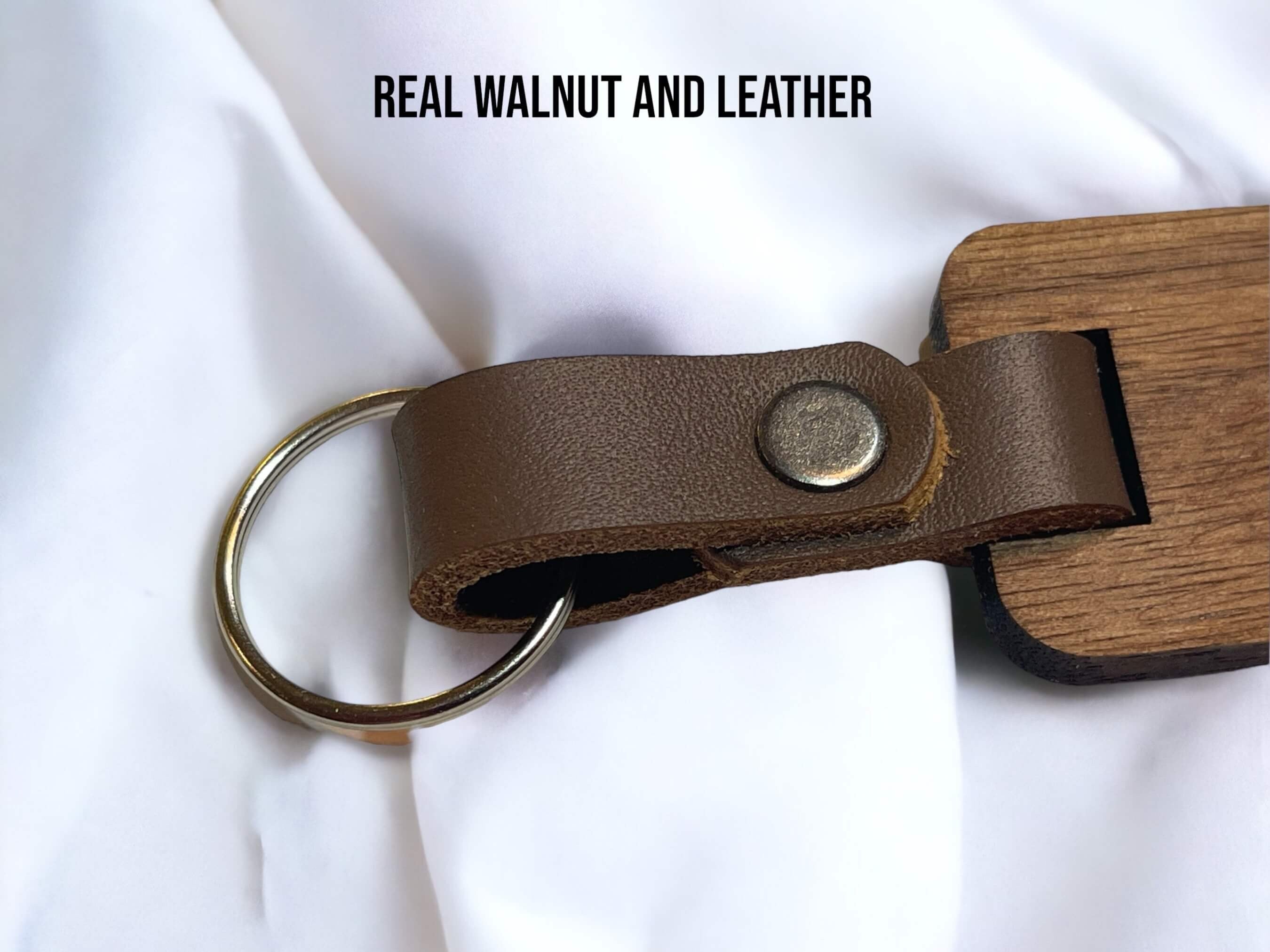 This is an up-close photo showing the real natural leather strap that we hand cut to make our walnut keyrings. 