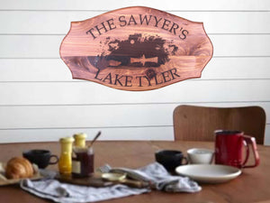 Customizable Cedar Lake House Plaque" Description: A stunning cedar plaque featuring a laser-engraved image of a man fishing in a small boat. The sign can be personalized with the customer's last name and lake name.