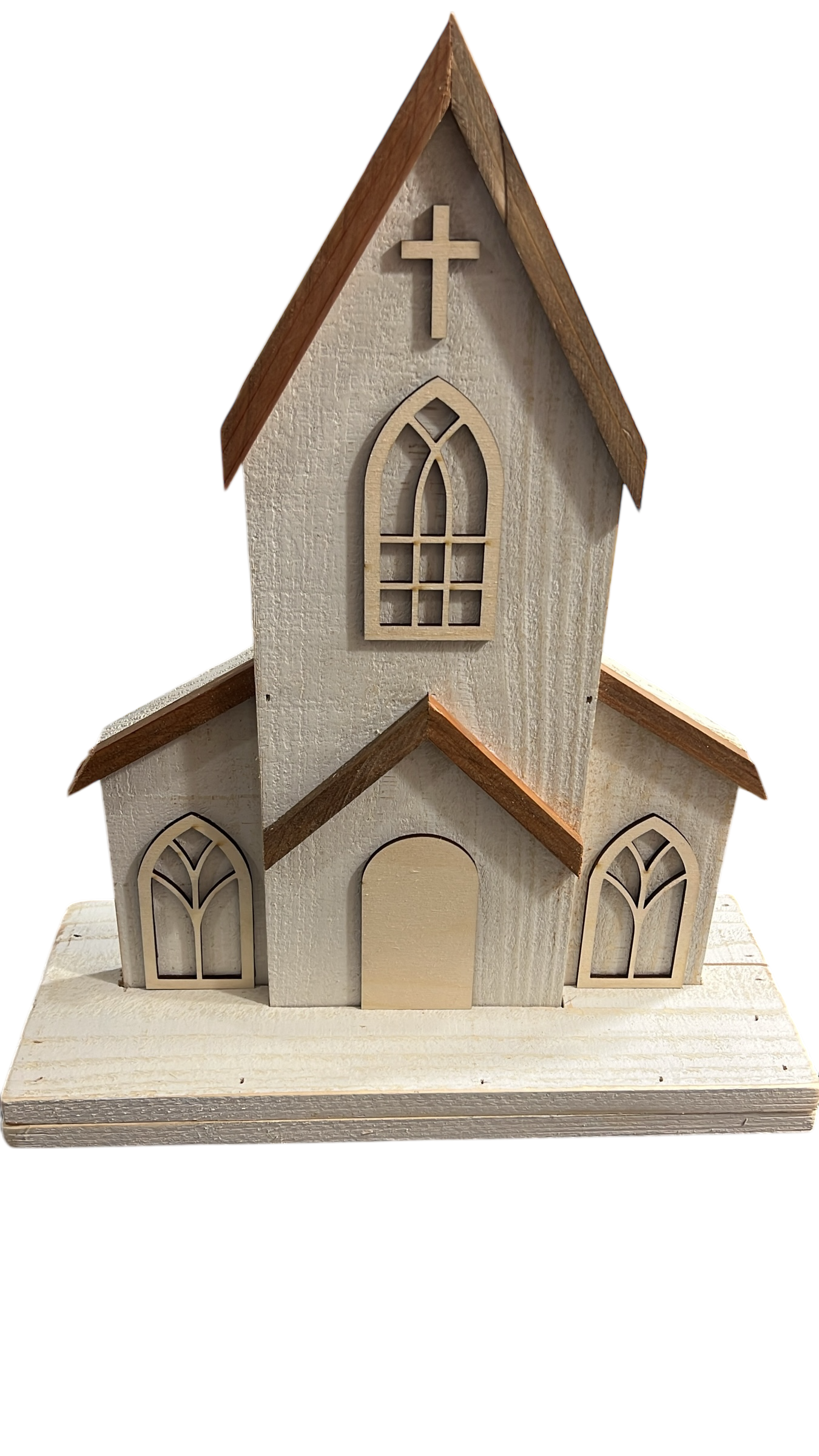 Close-up of handmade two-piece wooden church decor with engraved door option, distressed white finish, and natural cedar roof. Features arched windows and a wooden cross, perfect for rustic farmhouse or faith-inspired home decoration.