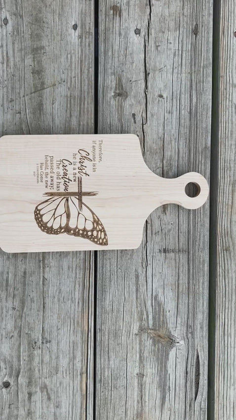 This is a video of the Bible Scripture Cutting Board. The cutting board has the bible verse of 2 Corinthians 5:17 laser engraved onto it. See more at SawyerCustomCrafts.com