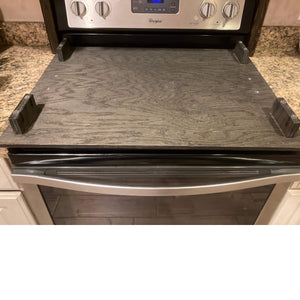 This is a picture of the underneath of the stove top cover. It shows the installed wooden legs that are installed to lift the stove cover up and the protective rubber feet that are placed on the bottom of those to protect the stove top. 