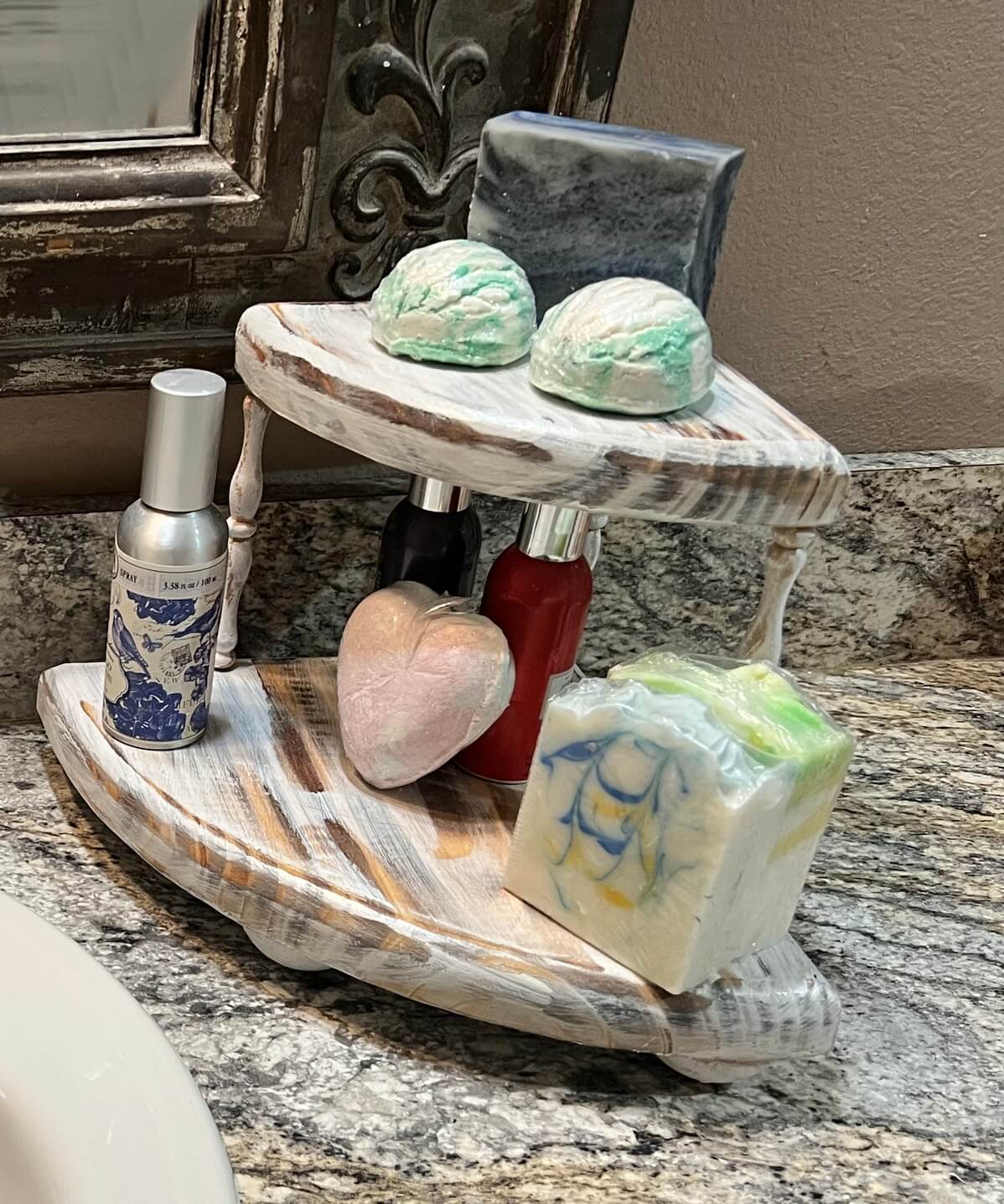 Boho wooden Riser shown here on the right side of sink on bathroom countertop. works great for displaying perfumes or bath bomb display.