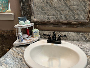 Minimalist Corner Pedestal Vanity shown here on the Left side of sink on bathroom countertop.