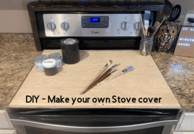 Picture of DiY Stove Top Cover shown with Cans of Paint and some Paint brushes on it. Image found at SawyerCustomCrafts.com