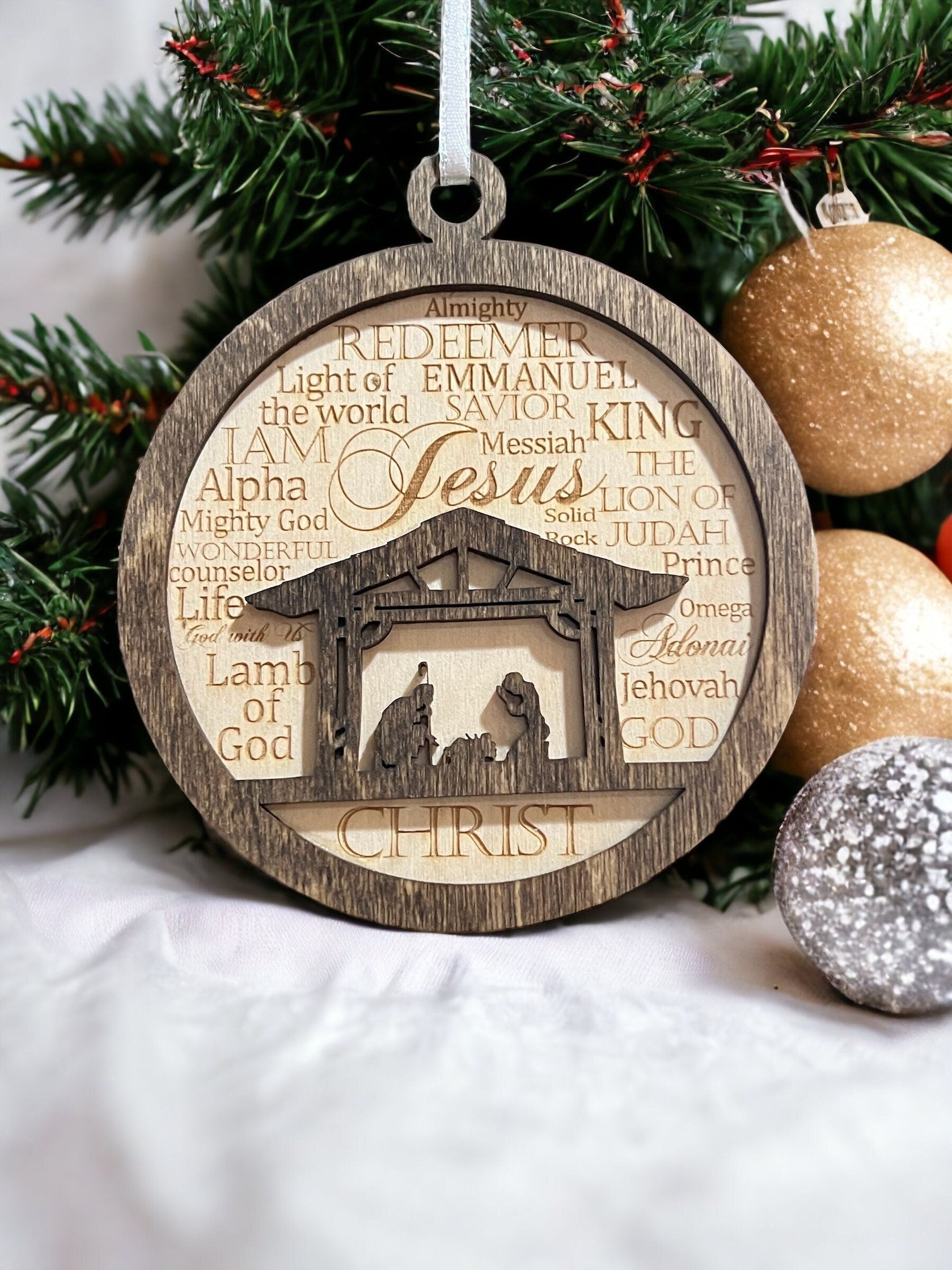 This Christmas baubble has the names of God engraved into it, all designed around a manger scene on the inside. SawyerCustomCrafts.Com