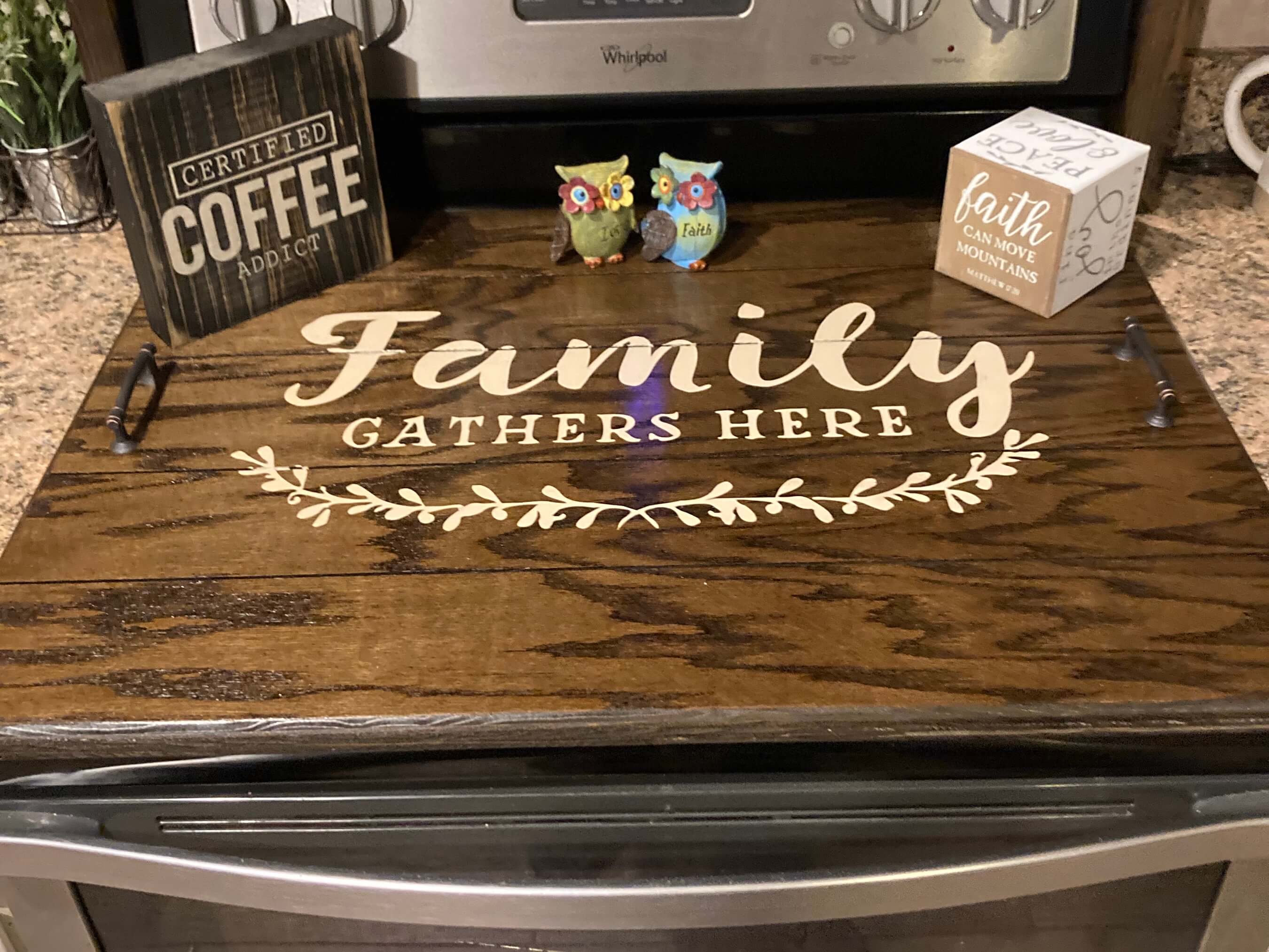 Modern Farmhouse Stovetop Cover stained in Dark walnut with cream words which say "Family Gathers Here". See more at Sawyercustomcrafts.com